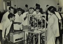 Participants of a short-term course in high-vacuum technology watch a demonstration