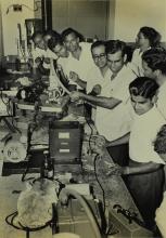 Participants of a short-term course in high-vacuum technology watch a demonstration