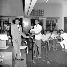 A judge congratulating a student at the annual Literary and Cultural Week