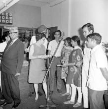 The participants of a competition, possibly German recitation, at the annual Literary and Cultural Week receiving a prize from the judge