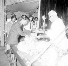 Dr. P. Subbarayan (Union Minister of Transport and Communications) hands over a prize to a student