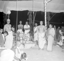 Idols decorated with flower garlands on a swing, 1965