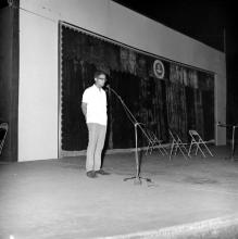 A student singing a song (probably) as part of the Entertainment Competition at the annual Literary and Cultural Week