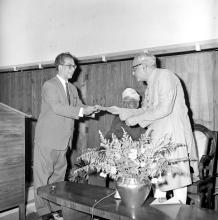 Prof. B. Sengupto presents a cheque towards the National Defence fund to Mr. M.C. Chagla (Union Minister for Education) at a formal event held on the occasion of his visit to the Institute