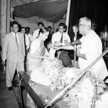 Dr. P. Subbarayan gives away prize to a woman who is possibly Ms. Rukmini/ Ms. Radha