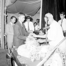 Dr. P. Subbarayan hands over a prize to Mr. Shivaram 