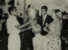 Mrs. Ann Lohmann Fischer gives away a trophy at the first Inter-Collegiate Sports Meet, 1964