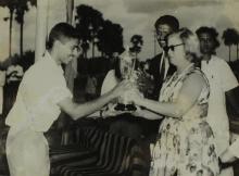 Mrs. Ann Lohmann Fischer gives away a trophy to a student at the first Inter-Collegiate Sports Meet, 1964