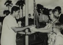 Mrs. Ann Lohmann Fischer gives away a prize to a student at the first Inter-Collegiate Sports Meet, 1964