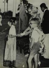 Mrs. Ann Lohmann Fischer gives away a prize to a young girl at the first Inter-Collegiate Sports Meet, 1964