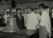 Prof. B. Sengupto and Minister V. R. Nedunchezhian discuss a large bell 