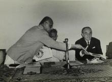 A brochure is distributed to the panel members of an event that is yet to be identified