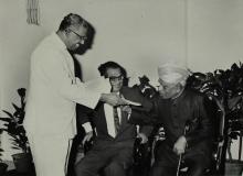 Dr. A. L. Mudaliar receives the 'Journal of Mathematical and Physical Sciences' from Mr. V. R. Nedunchezhian 