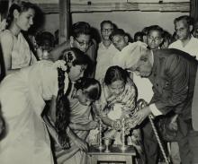 Dr. A. L. Mudaliar lights the lamp, marking the inauguration of the Central Library building