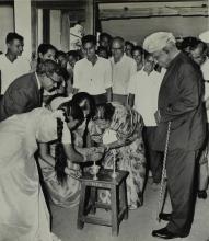 Dr. A. L. Mudaliar watches Mrs. Shanthi Sengupto light the lamp, marking the inauguration of the Central Library building