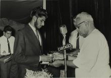 Dr. P. Subbarayan hands over a prize to Mr. Syed Abdul Aleem