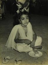 Mr. R. Natarajan's elder daughter, Priya, enjoys the refreshments served at the farewell ceremony organised for her father 