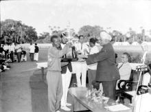 Mr. Simpson of IIT Kharagpur receives the General Championship Trophy at the Third Inter-IIT Sports Meet from Dr. A. L. Mudaliar, 1964