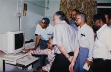 Prof. M. S. Ananth and others taking a look at a computer, 2003