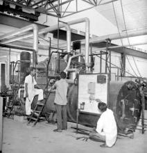 Attendants working on laboratory equipment