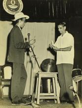 Mr. Gopal Ramachandran performs a magic trick as volunteer Prof. R. G. Narayanamurthi watches, 1966