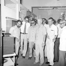 German visitors are briefed about equipment at a laboratory