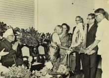 Mrs. Radha Bai receives a memento at the farewell function of Dr. A. L. Mudaliar
