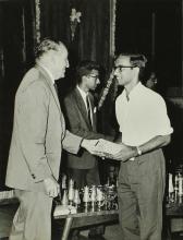 Dr. Karl Pfauter giving away a prize to a student at the Ninth Institute Day celebrations at the Open Air Theatre, 1968