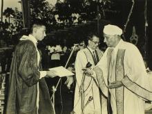 A student receives an award from Sir C. V. Raman