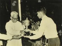 Mr. M. Bhaktavatsalam presents a trophy to a representative of Saraswathi Hostel, 1965