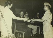 Mrs. Ujjal Singh presents an award to an officer, 1967 