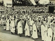 The academic procession, consisting of the Senate members, wends through the Open Air Theatre, as the audience stands