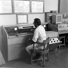 A faculty or staff member operating machinery at the Electrical Engineering Laboratory