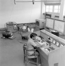 A professor or laboratory staff operating equipment at the Electrical Engineering Laboratory
