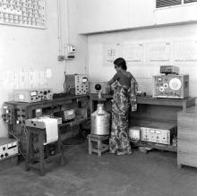 A laboratory attendant or student operating equipment