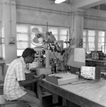 A laboratory attendant, student or professor operating equipment