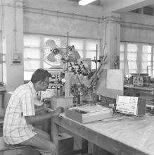 A laboratory attendant, student or professor operating equipment