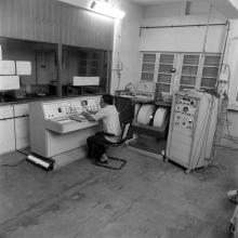 A laboratory attendant, student or professor operating equipment