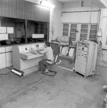 A laboratory attendant, student or professor operating equipment