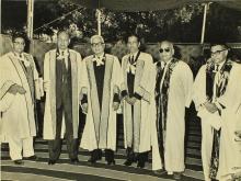 The distinguished guests pose for a photo in the academic robes