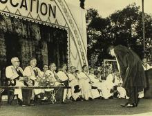 A graduate bows to the dignitaries after receiving his degree  