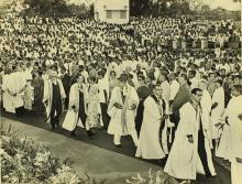 The academic procession enters the Open Air Theatre and makes its way to the dais