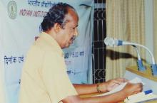 A speaker addresses a gathering at the 4th Hindi Workshop