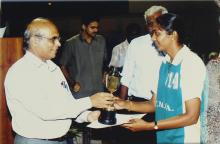 A basketball player is presented with a trophy by Prof. S. Narayanan, 2005