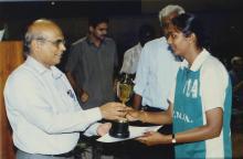 A basketball player is presented with a trophy by Prof. S. Narayanan, 2005