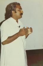 A speaker addresses the audience, 1999