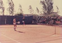 A tennis doubles match in progress, 1985