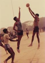 An IIT Madras basketball player takes a jump shot, 1985