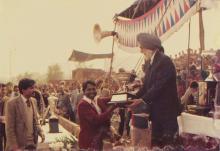 A person receives a trophy at the 22nd Inter-IIT Sports Meet, 1985