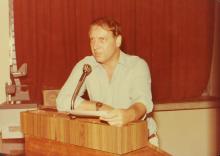 A gentleman addresses a gathering during an event
